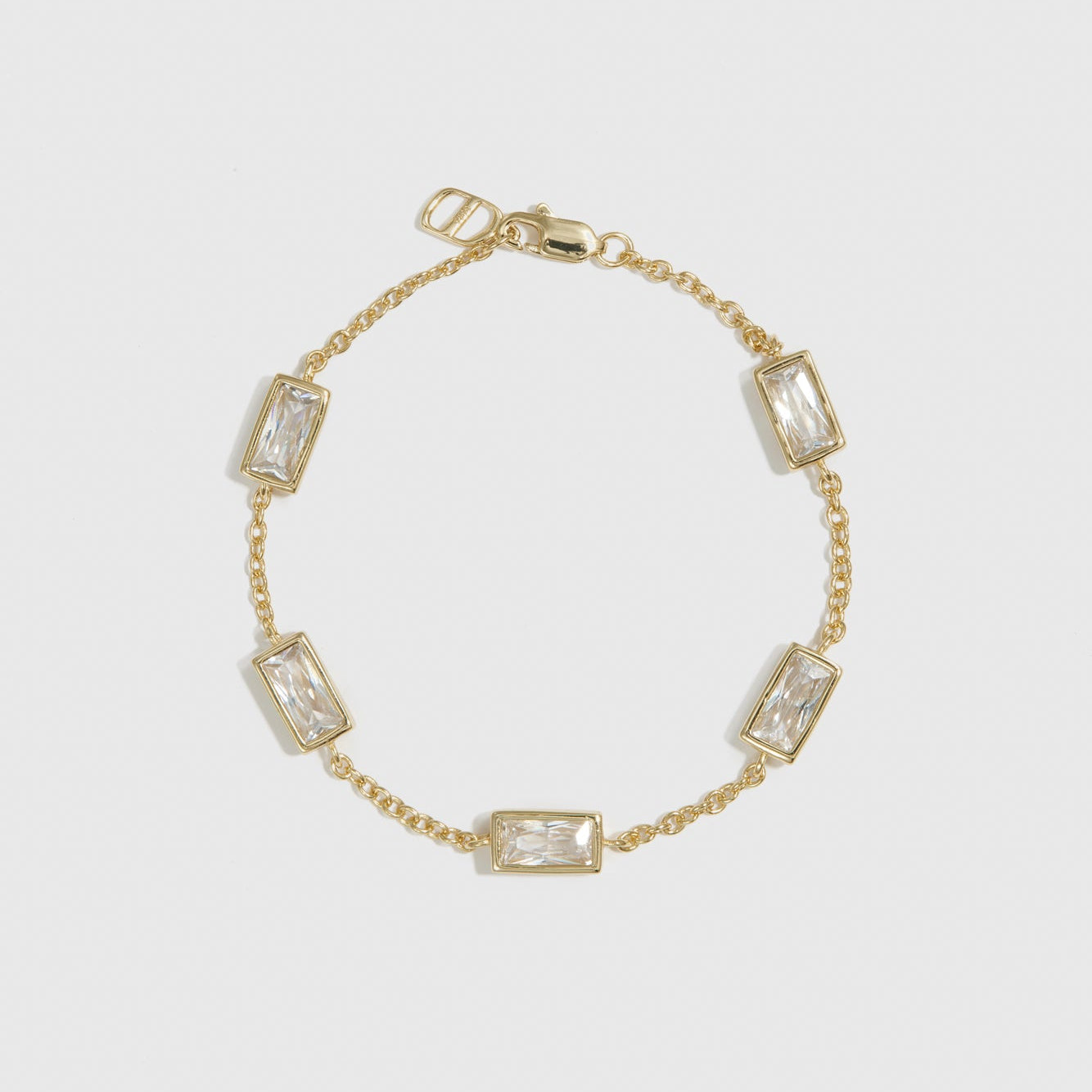 14k gold plated sterling silver 925 baguette-cut multi bezel bracelet with cubic zirconia, shown on a plain background.