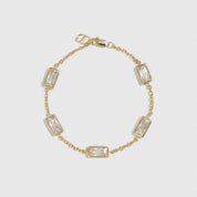 14k gold plated sterling silver 925 baguette-cut multi bezel bracelet with cubic zirconia, shown on a plain background.