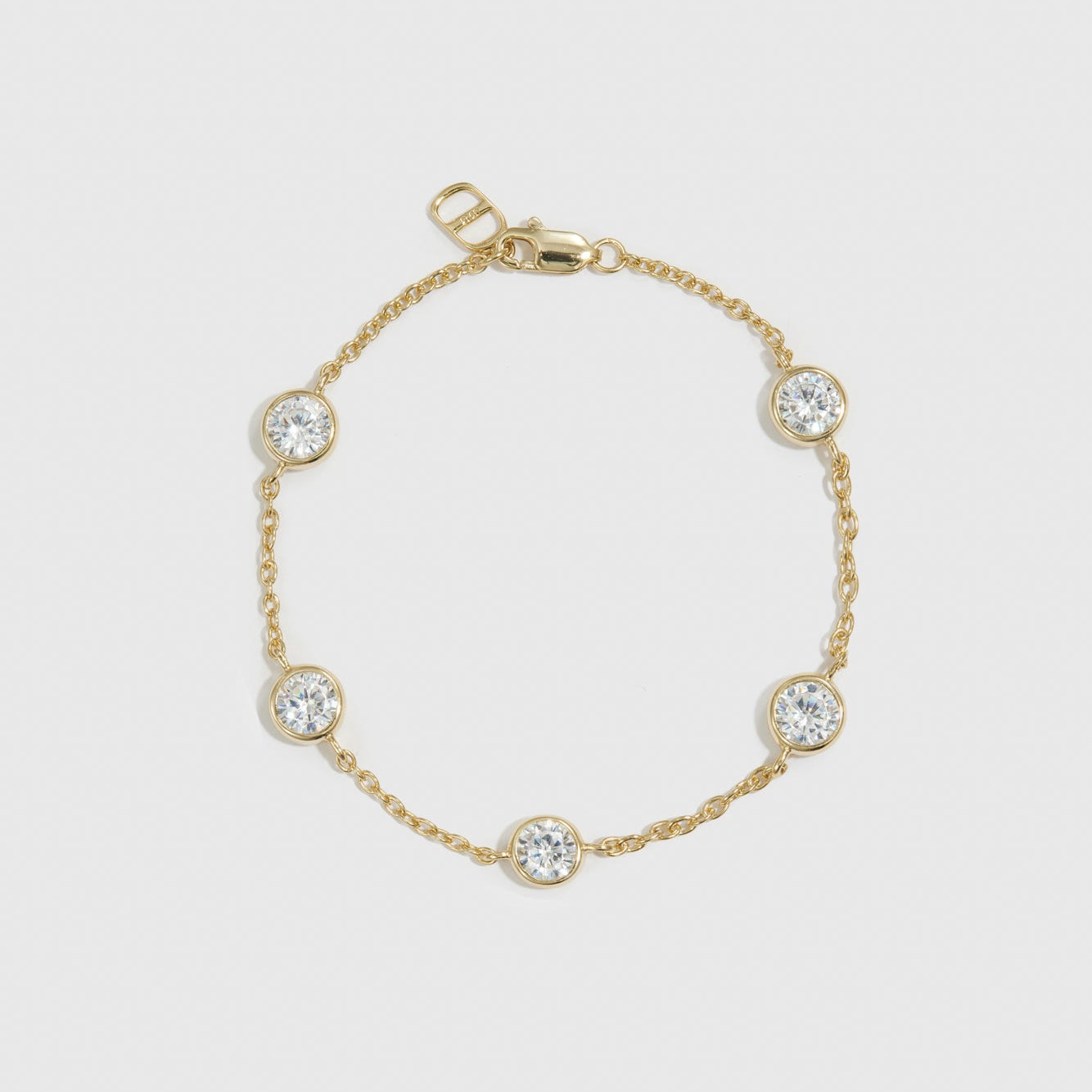 14k gold plated sterling silver 925 round-cut multi bezel bracelet with cubic zirconia, shown on a plain background.