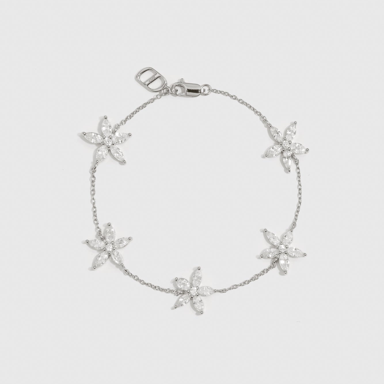 Sterling silver 925 flower multi bracelet with cubic zirconia flowers, shown on a plain background.