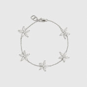 Sterling silver 925 flower multi bracelet with cubic zirconia flowers, shown on a plain background.