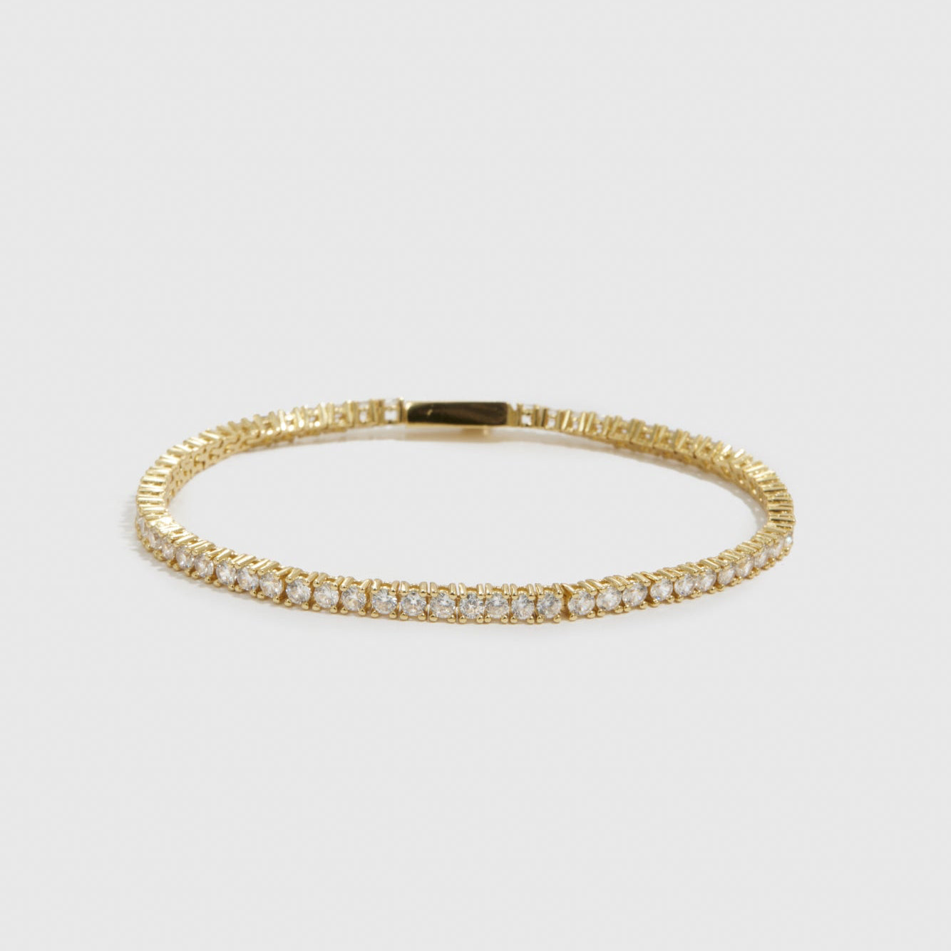14k gold plated dainty tennis bracelet with cubic zirconia, shown on a plain background.