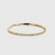 14k gold plated dainty tennis bracelet with cubic zirconia, shown on a plain background.