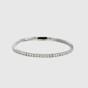 Silver plated dainty tennis bracelet with cubic zirconia, shown on a plain background.