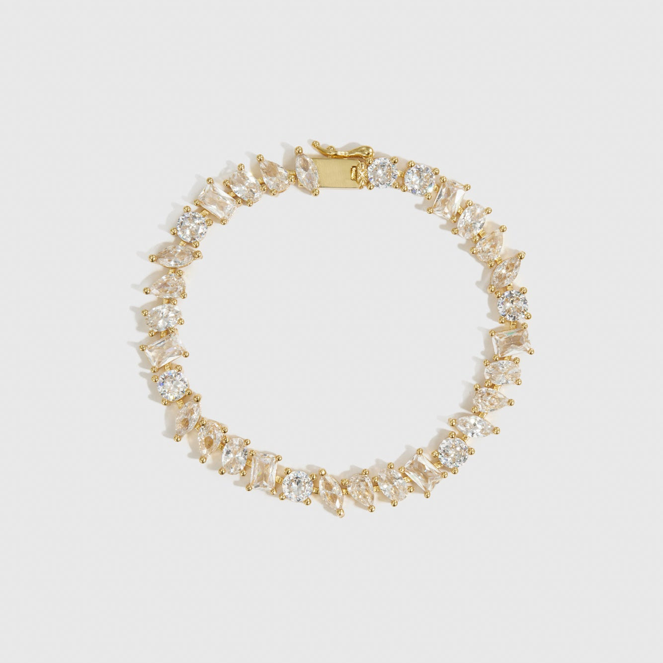 14k gold plated multi-cut tennis bracelet with cubic zirconia, shown on a plain background.