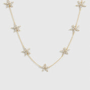 14k gold plated sterling silver 925 flower multi necklace with cubic zirconia flowers, shown on a plain background.