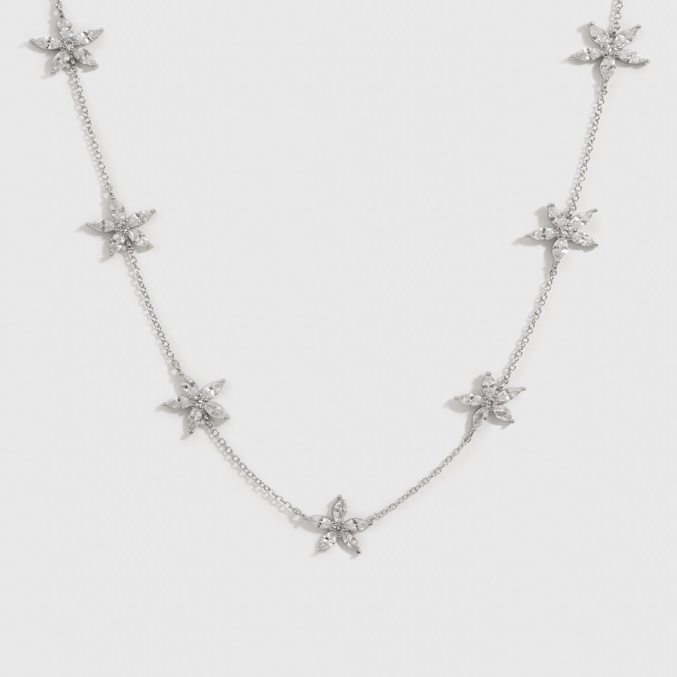 Sterling silver 925 flower multi necklace with cubic zirconia flowers, shown on a plain background.