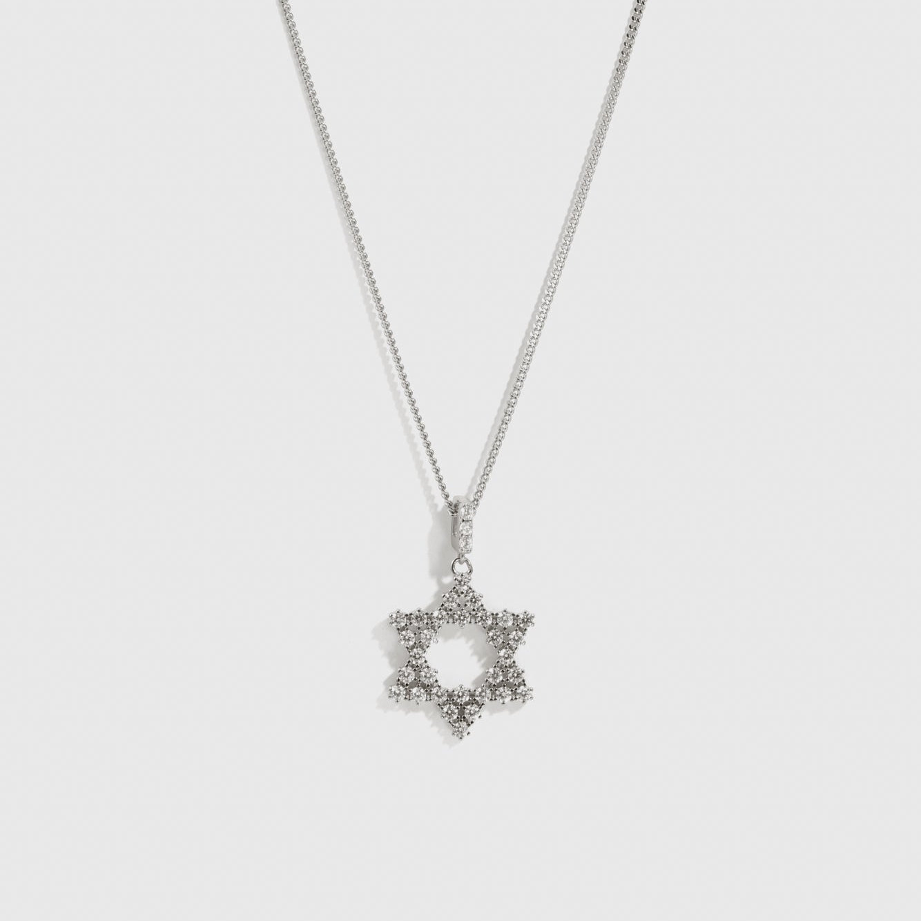 Silver Star of David pendant necklace with cubic zirconia, shown on a plain background.