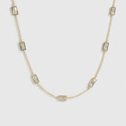 14k gold plated sterling silver 925 baguette-cut multi bezel necklace with cubic zirconia, shown on a plain background.