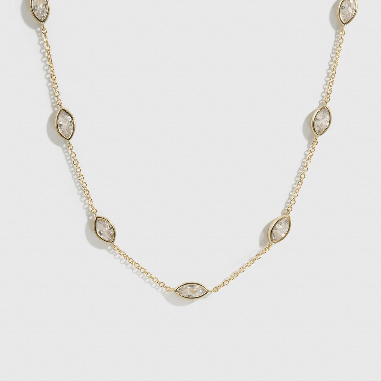 14k gold plated sterling silver 925 marquise-cut multi bezel necklace with cubic zirconia, shown on a plain background.