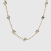14k gold plated sterling silver 925 round-cut multi bezel necklace with cubic zirconia, shown on a plain background.