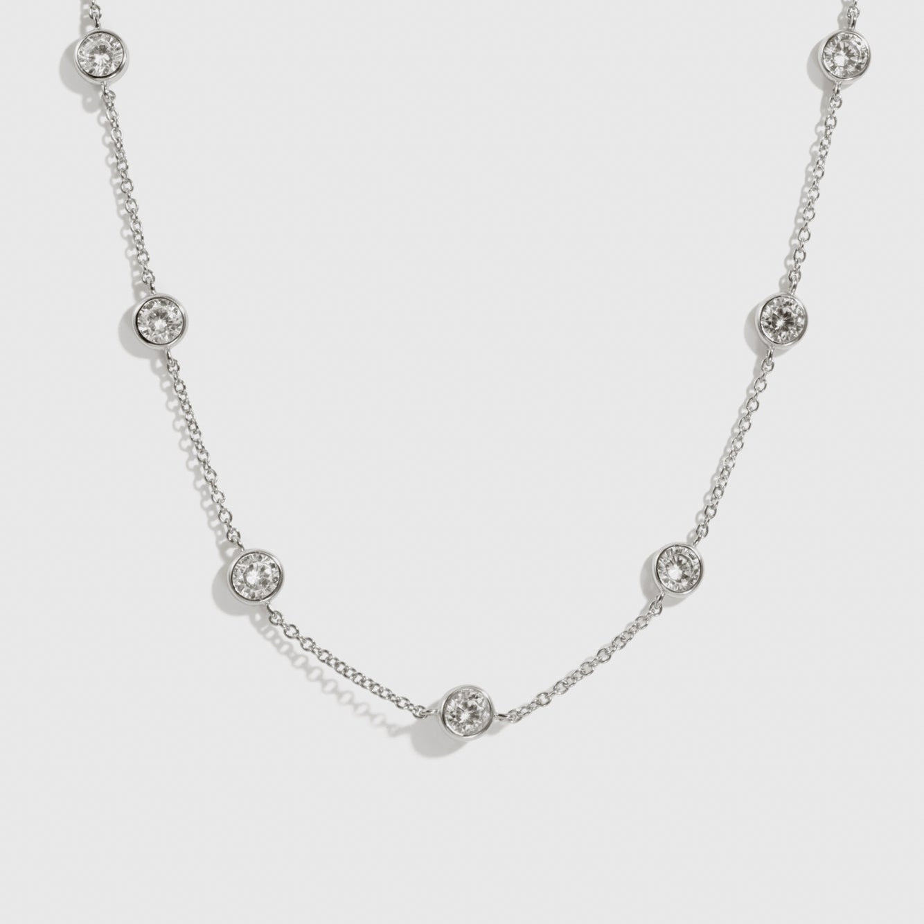 Sterling silver 925 round-cut multi bezel necklace with cubic zirconia, shown on a plain background.