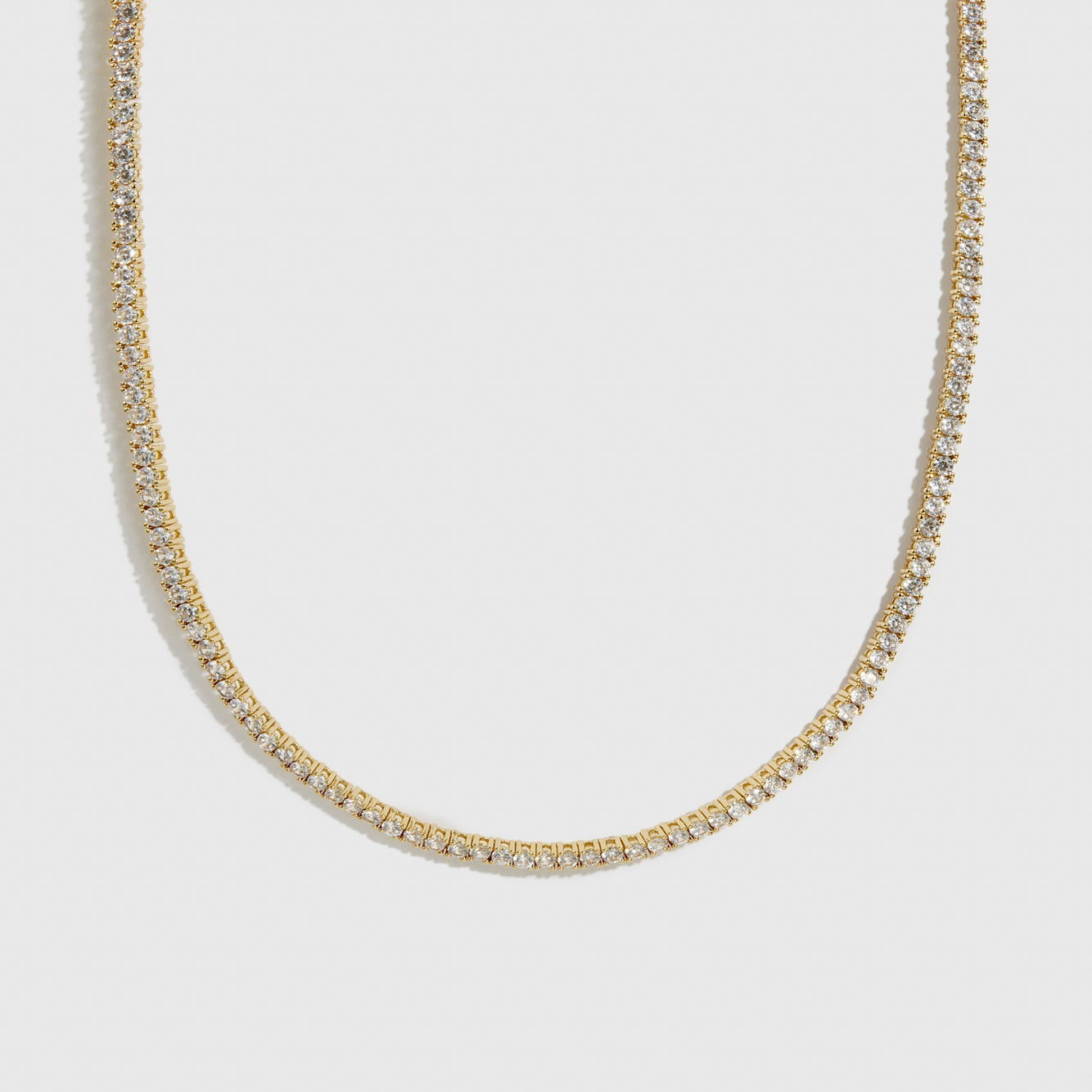 14k gold plated dainty tennis choker with cubic zirconia, shown on a plain background.
