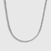 Silver plated dainty tennis necklace with cubic zirconia, shown on a plain background.