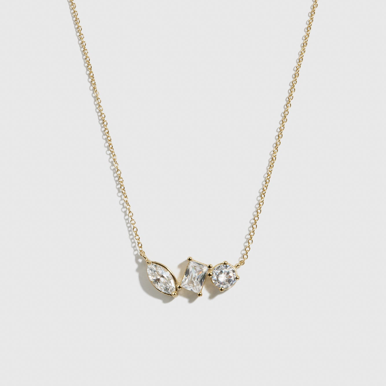 14k gold plated sterling silver 925 trio-cut dainty necklace with cubic zirconia, shown on a plain background.