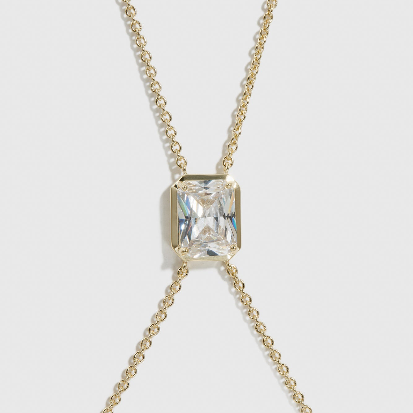 14k gold plated baguette-cut body chain with a cubic zirconia pendant, shown on a plain background.