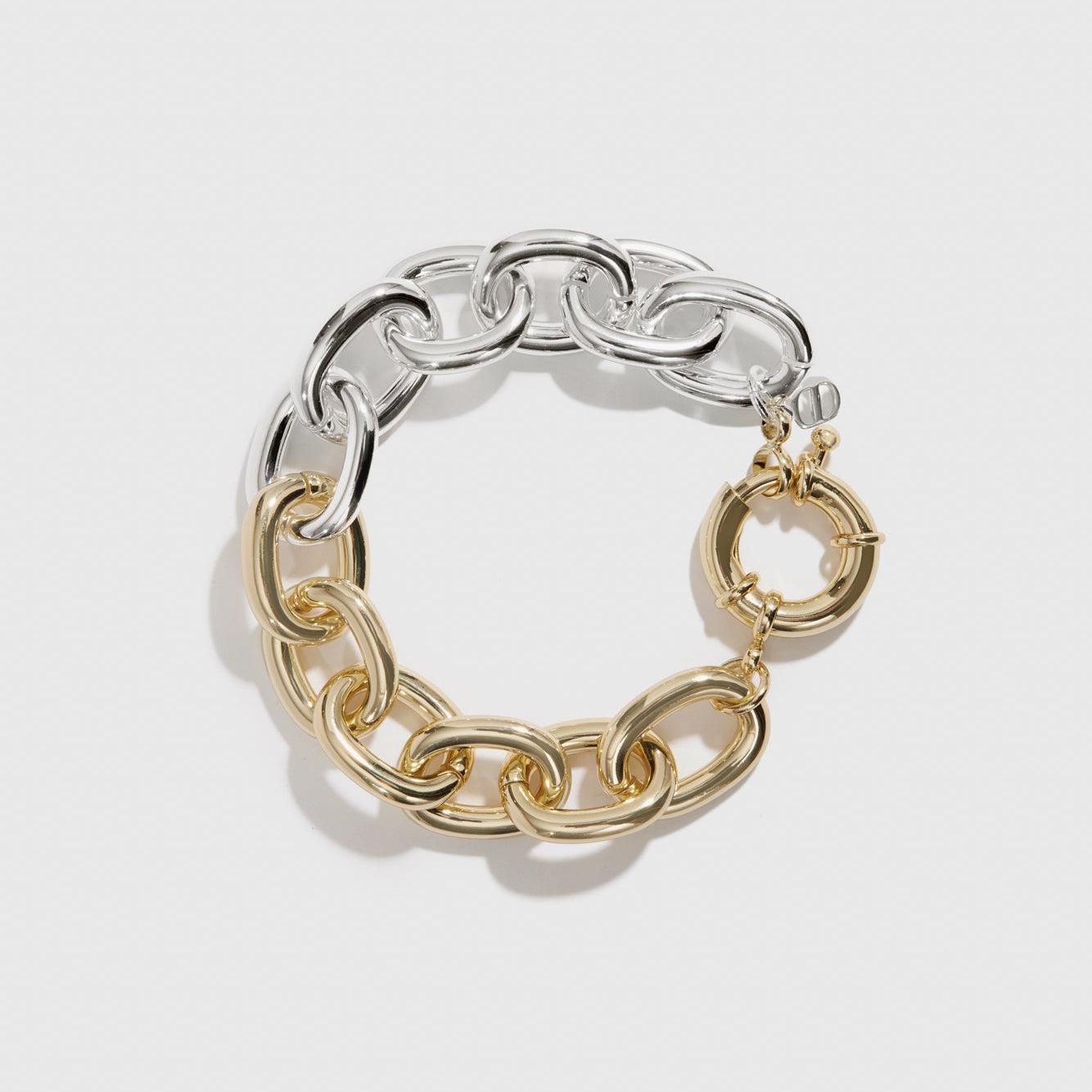 Mixed metal oval link bracelet, shown on a plain background.