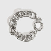 Silver plated oval link pavé bracelet with pavé cubic zirconia, shown on a plain background.