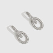 Silver plated oval link pavé pendant hoops with pavé cubic zirconia, shown on a plain background.