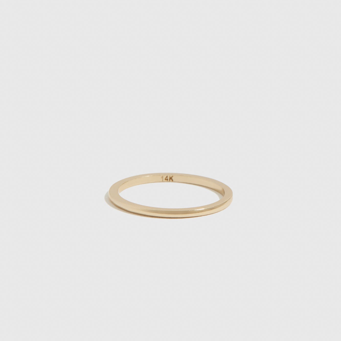 14k solid gold delicate ring, shown on a plain background.