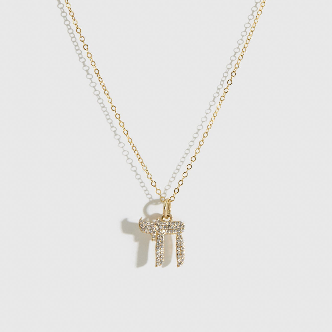 14k solid gold Chai pavé pendant necklace with cubic zirconia or lab-grown diamonds, shown on a plain background.