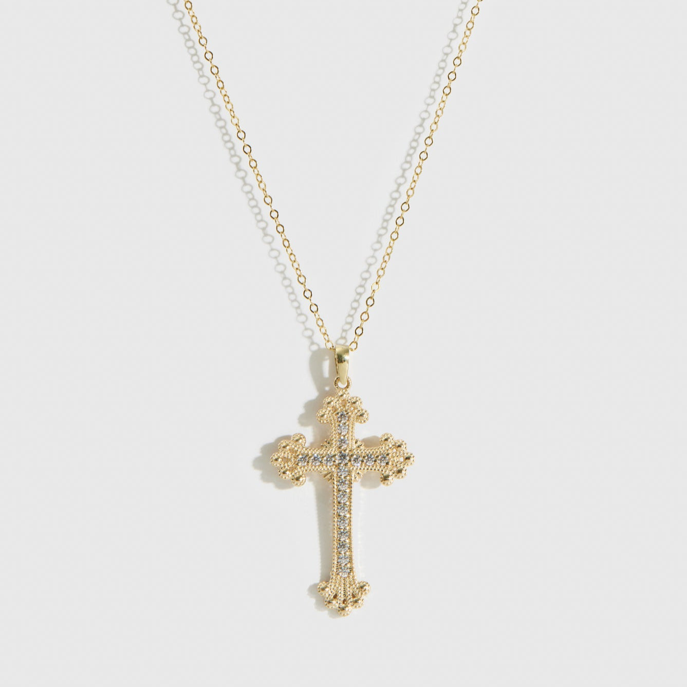 14k solid gold goth cross pavé pendant necklace with cubic zirconia or lab-grown diamonds, shown on a plain background.