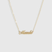 14k solid gold personalized cursive font nameplate necklace, shown on a plain background.