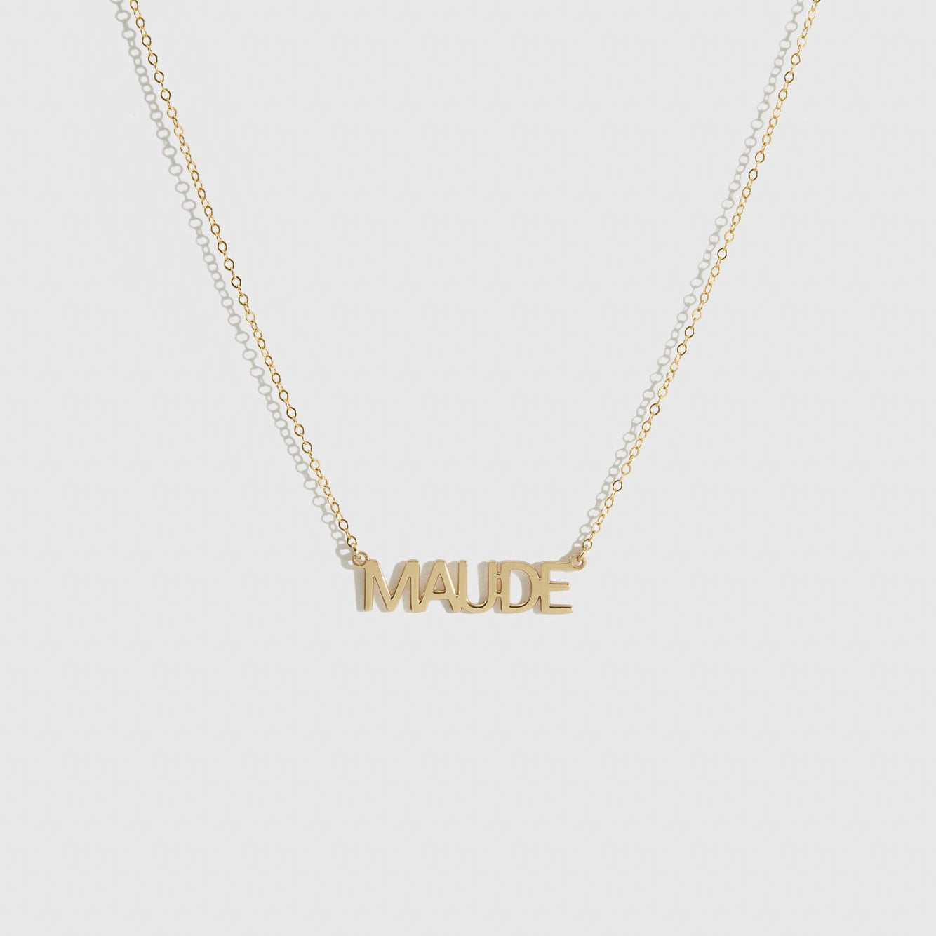 14k solid gold personalized block font nameplate necklace, shown on a plain background.