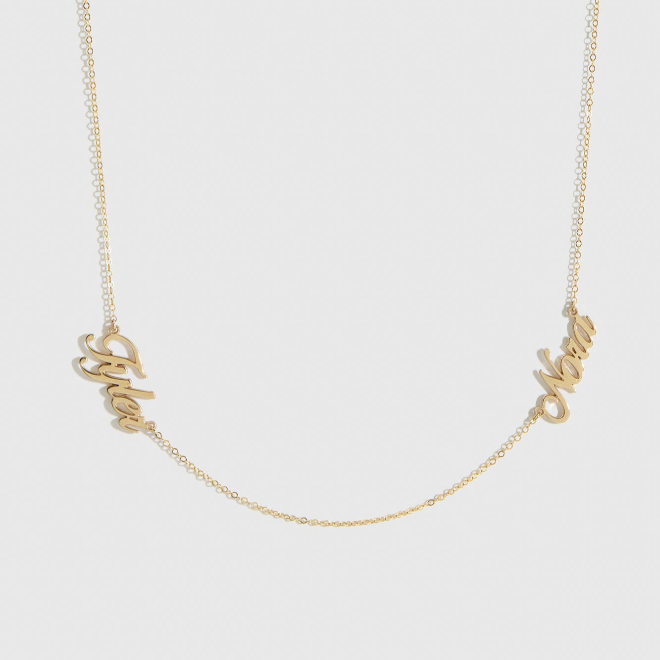 14k solid gold personalized cursive font two nameplates necklace, shown on a plain background.