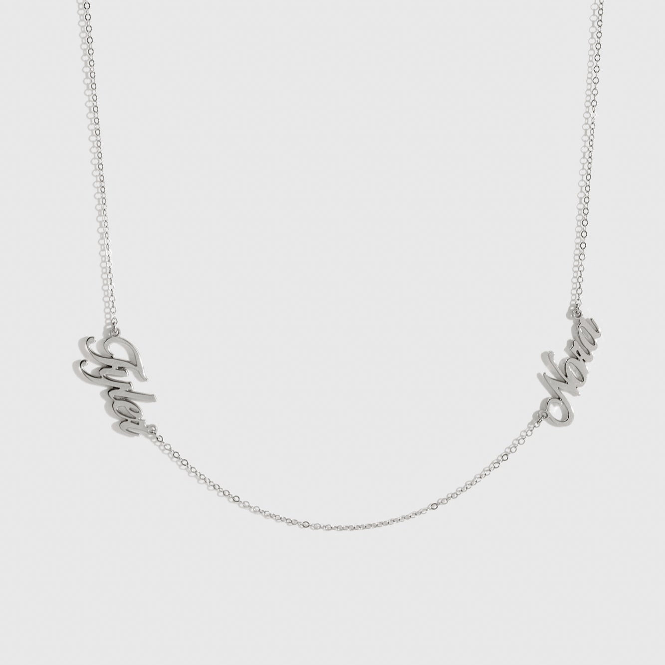 Sterling silver 925 personalized cursive font two nameplates necklace, shown on a plain background.