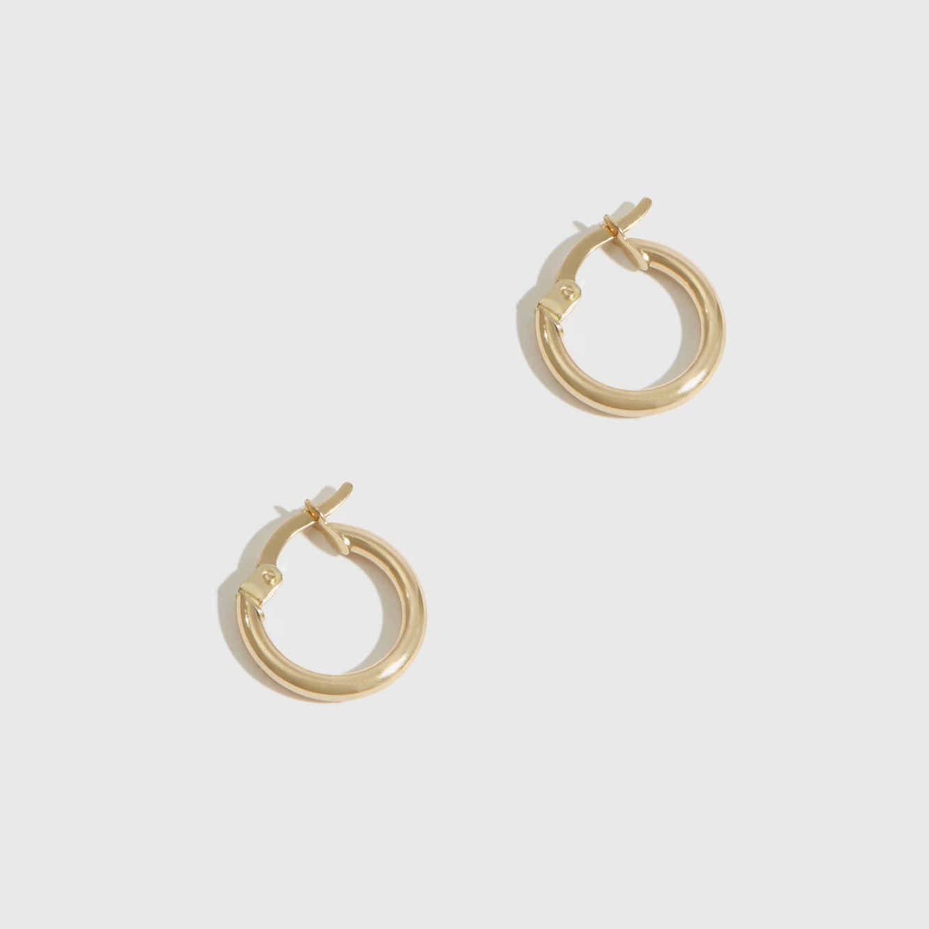 14k solid gold mini tube hoops, shown on a plain background.