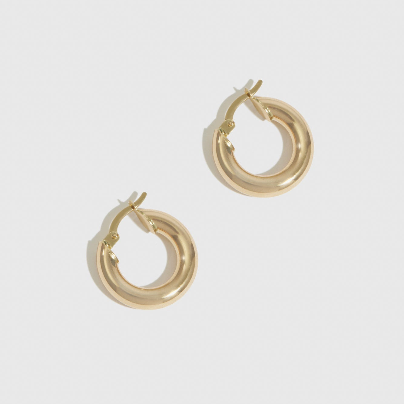 14k solid gold chunky tube hoops, shown on a plain background.
