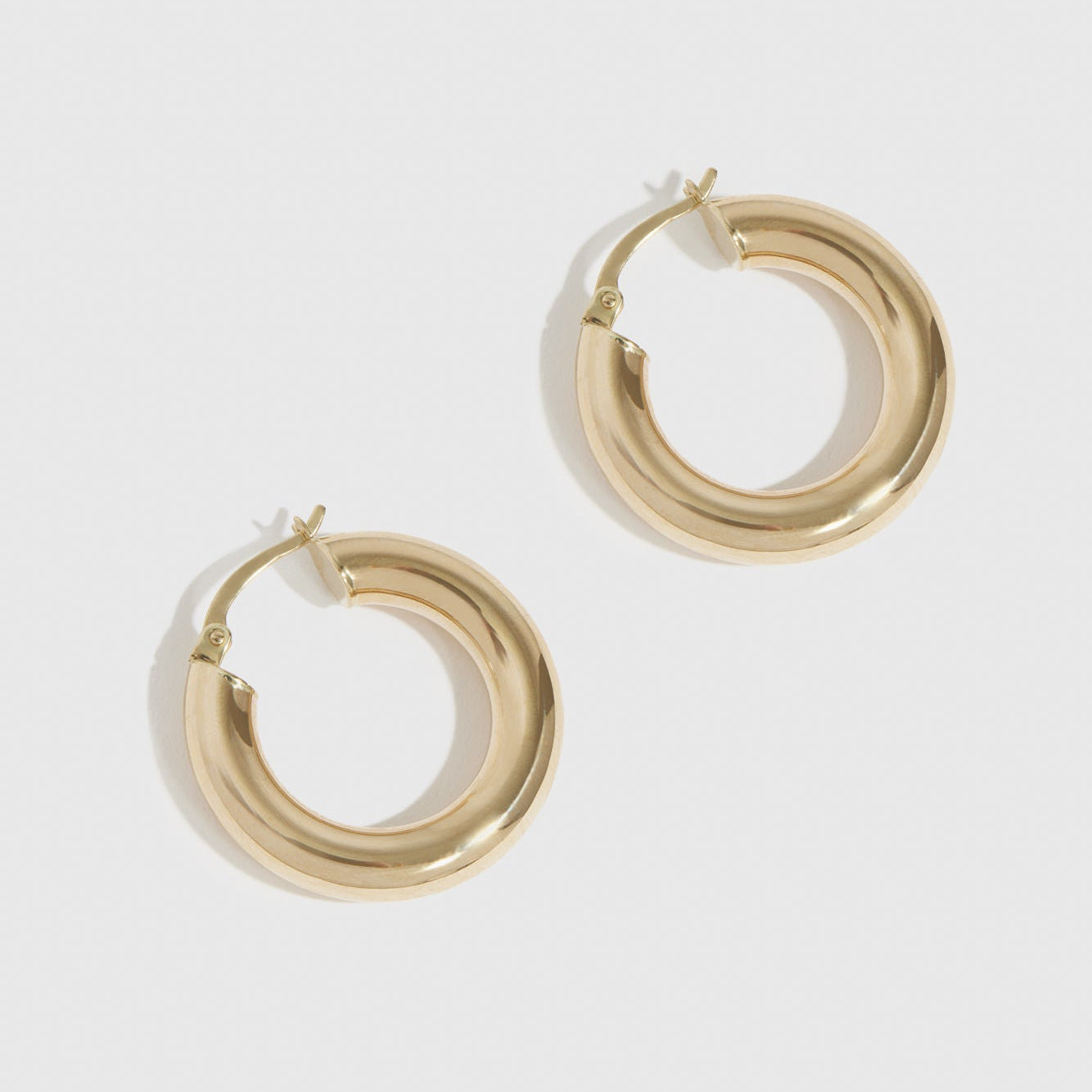 14k solid gold classic tube hoops, shown on a plain background.