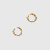 14k solid gold classic huggie hoops, shown on a plain background.