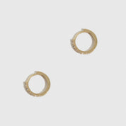 14k solid gold mini pavé huggie hoops with cubic zirconia or lab-grown diamonds, shown on a plain background.