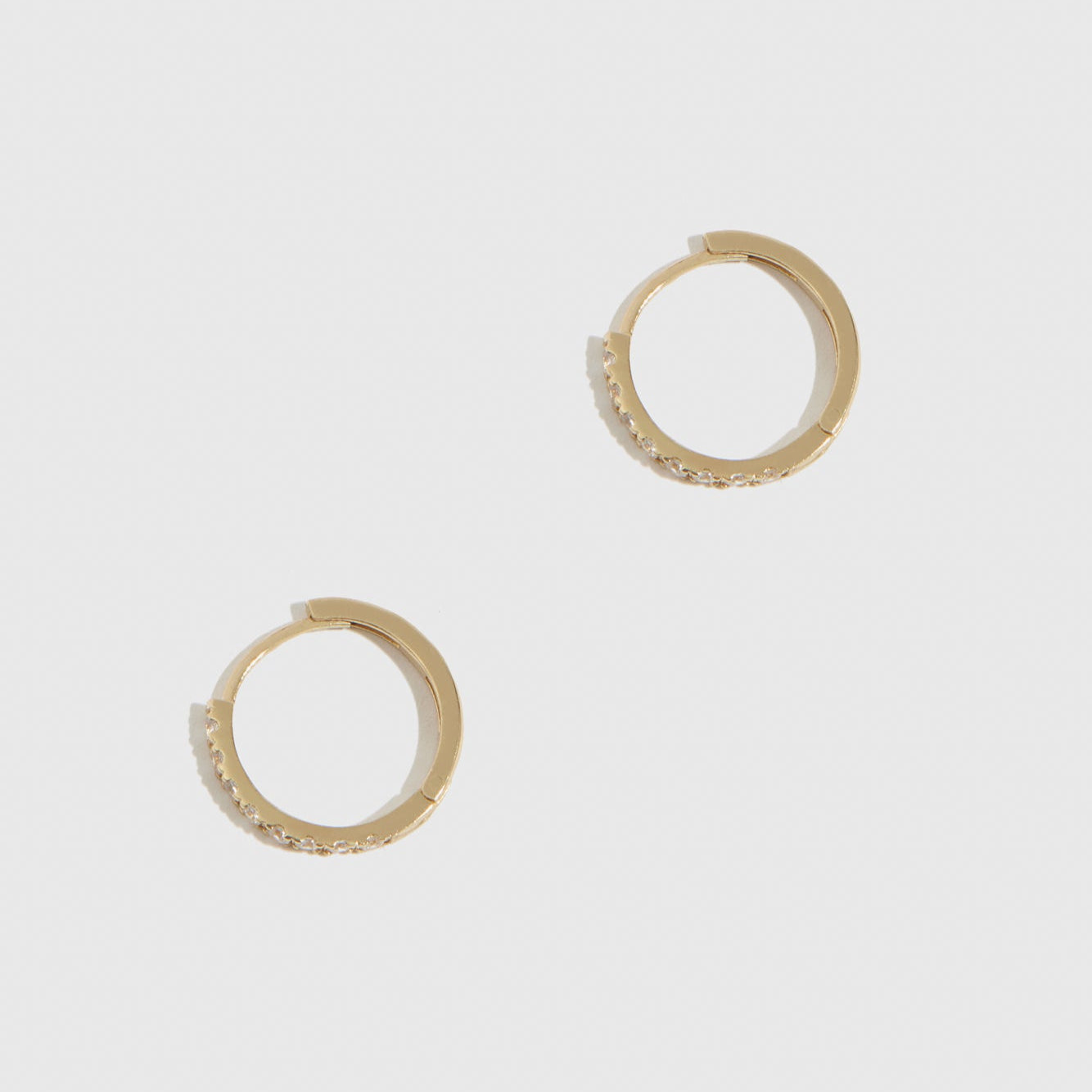 14k solid gold classic huggie pavé hoops with cubic zirconia or lab-grown diamonds, shown on a plain background.