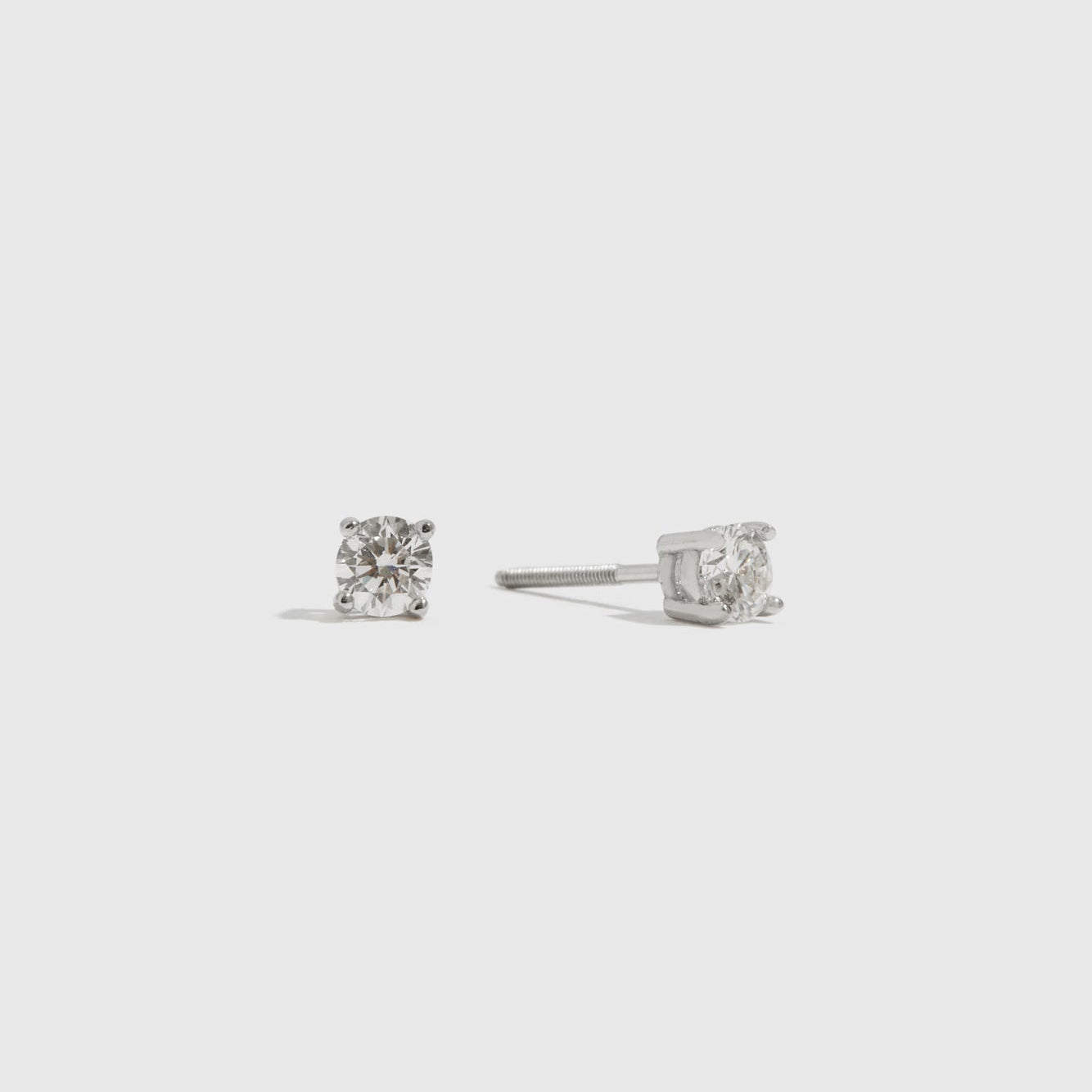 14k solid white gold rhodium plated solitaire lab-grown diamond studs, shown on a plain background.