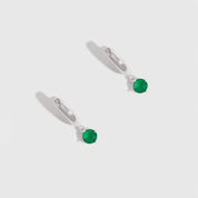 Pair of earrings with green gemstones on a white background