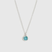 Silver necklace with a blue gemstone pendant on a white background