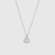 Necklace with a small round pendant on a light gray background