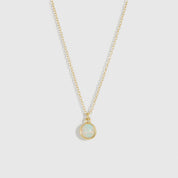Necklace with a round pendant on a light gray background