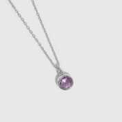 Necklace with a purple gemstone pendant on a light gray background