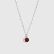 Gold necklace with star, moon, and 'MAXX' pendant on a white background