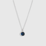 Necklace with a blue gemstone on a white background