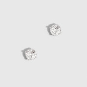 Pair of silver stud earrings on a light gray background