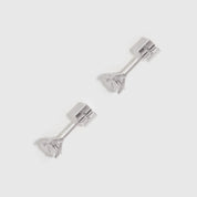 Pair of silver stud earrings on a light gray background