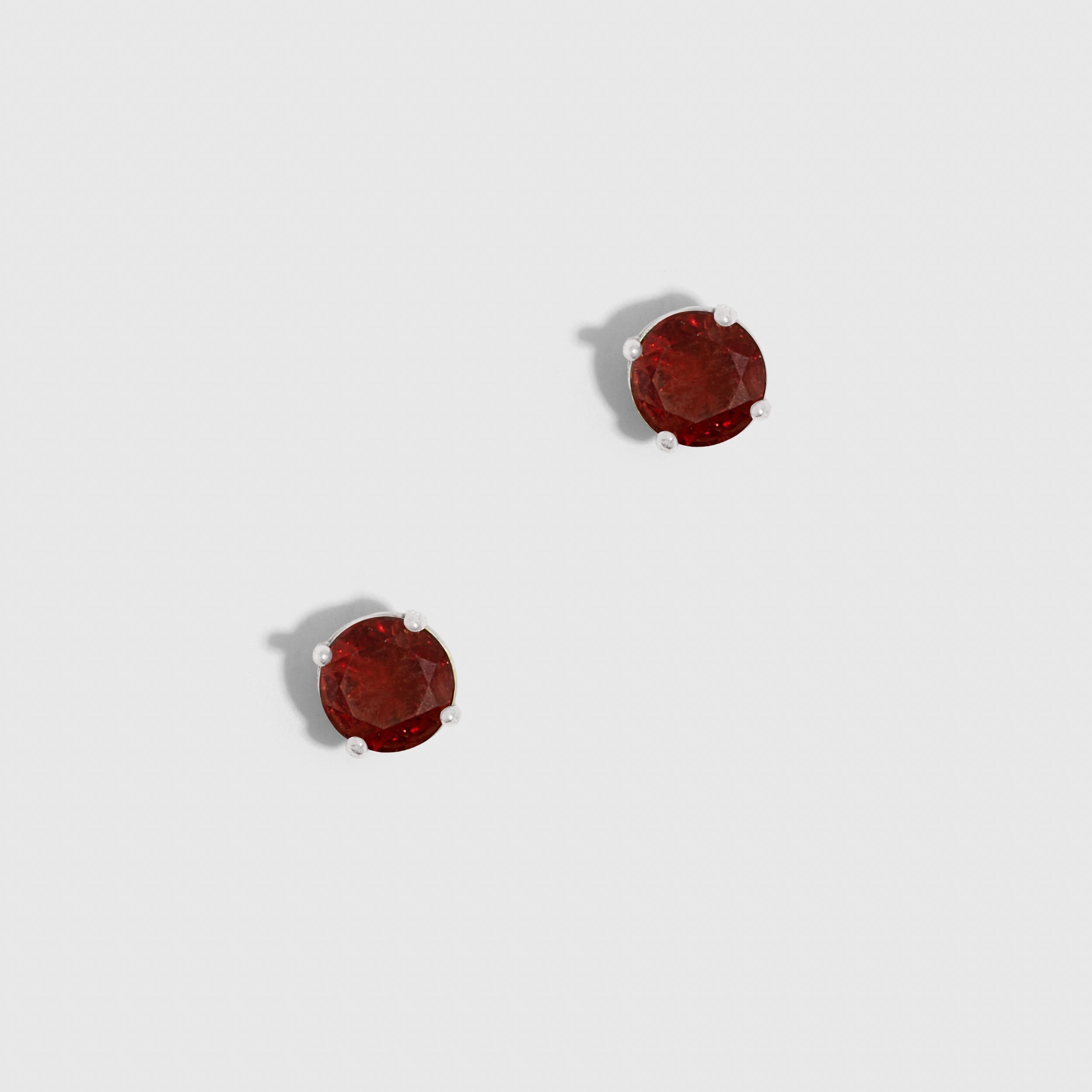Pair of red earrings on a white background