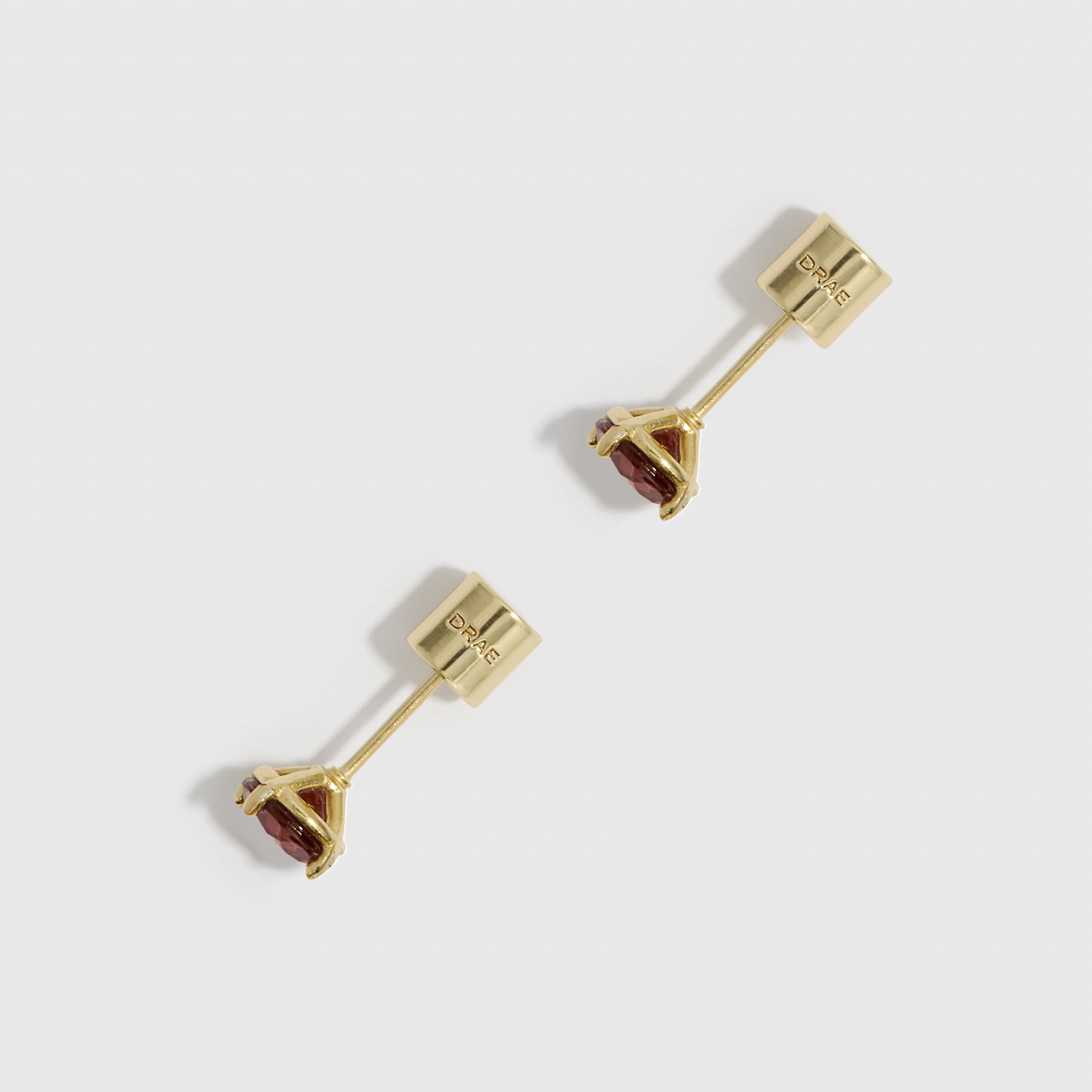 Gold earrings with gemstones on a white background