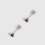 Pair of silver earrings with gemstones on a white background