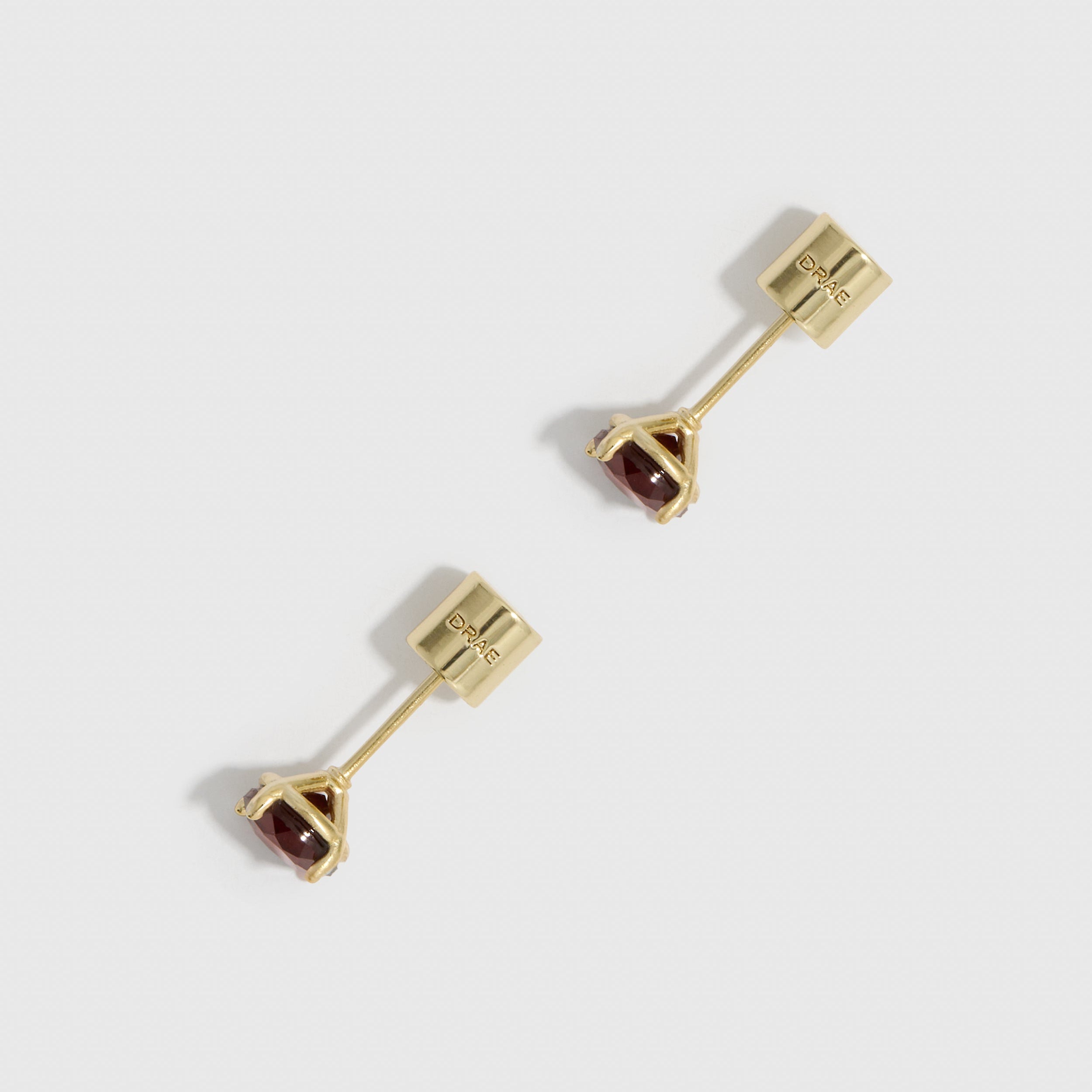 Gold earrings with gemstones on a white background
